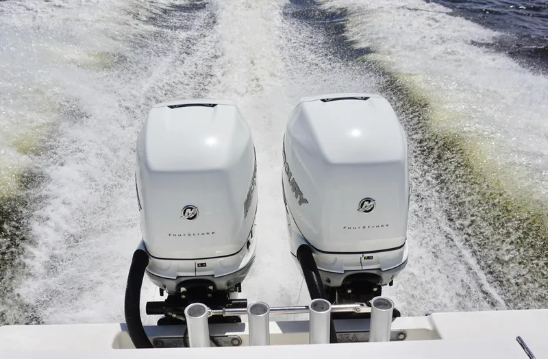  Yacht Photos Pics Twin Mercury outboard engines on a 2009 SeaVee 32OB boat, creating a wake.