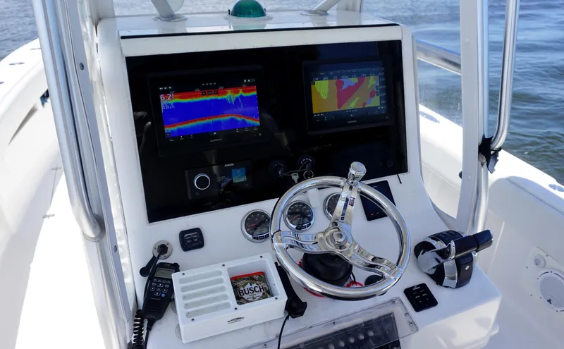  Yacht Photos Pics 2009 SeaVee 32OB boat console with navigation screens, steering wheel, and controls on open water.
