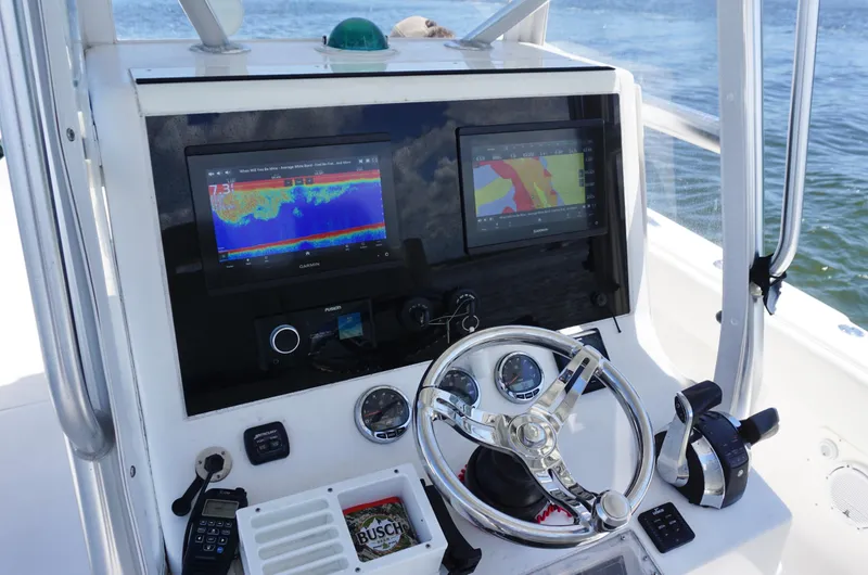  Yacht Photos Pics 2009 SeaVee 32OB boat dashboard with dual navigation screens and steering wheel.