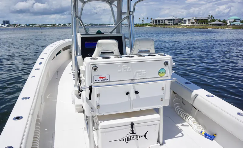  Yacht Photos Pics 2009 SeaVee 32OB boat on water, featuring center console and seating, under a partly cloudy sky.
