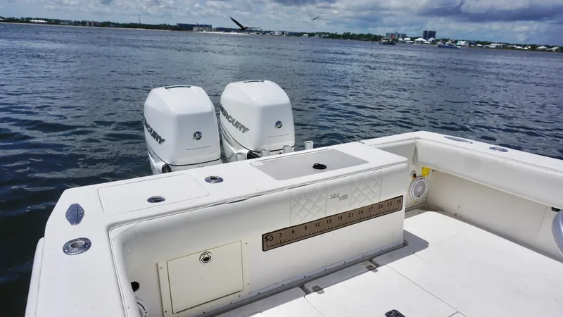  Yacht Photos Pics 2009 SeaVee 32OB boat with twin outboard engines on a calm water backdrop.