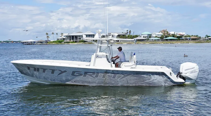  Yacht Photos Pics 2009 SeaVee 32OB boat on water, side view, with person at helm, coastal background.