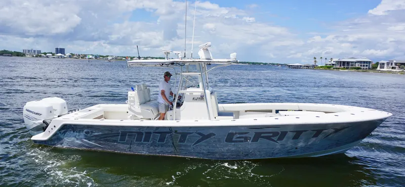  Yacht Photos Pics 2009 SeaVee 32OB boat on water, clear sky, person onboard, coastal background.