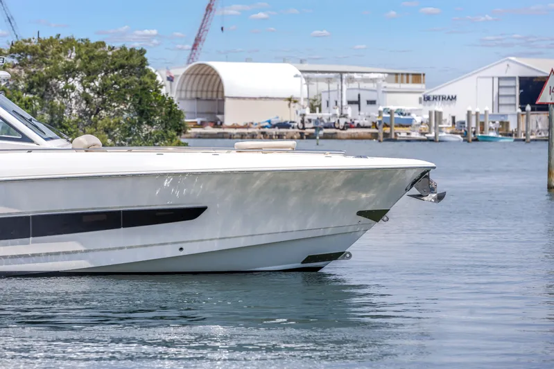  Yacht Photos Pics 2018 Boston Whaler 420 Outrage boat docked near industrial buildings.