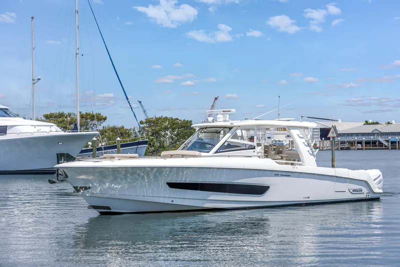  Yacht Photos Pics 2018 Boston Whaler 420 Outrage boat on calm water under blue sky.
