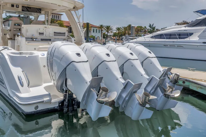  Yacht Photos Pics 2018 Boston Whaler 420 Outrage with four powerful outboard engines docked at marina.