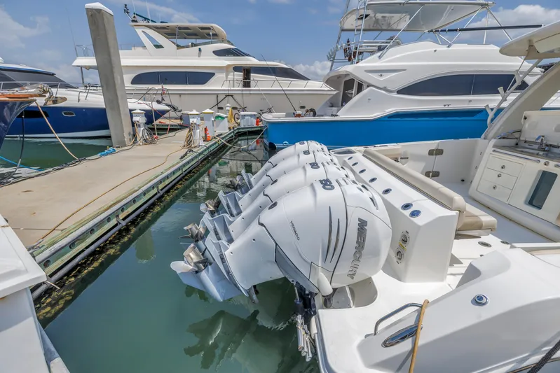  Yacht Photos Pics 2018 Boston Whaler 420 Outrage docked, featuring powerful outboard engines, surrounded by luxury yachts.