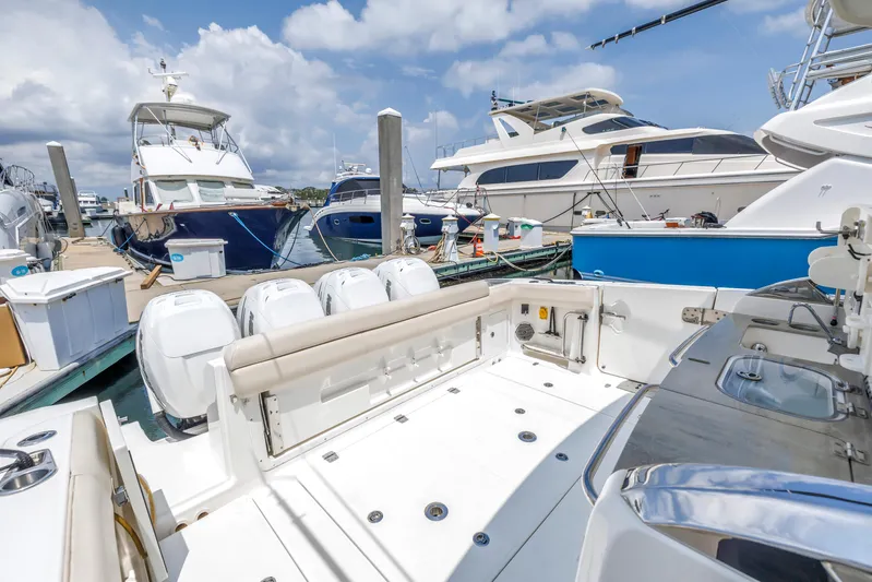  Yacht Photos Pics 2018 Boston Whaler 420 Outrage docked among luxury yachts under a blue sky.