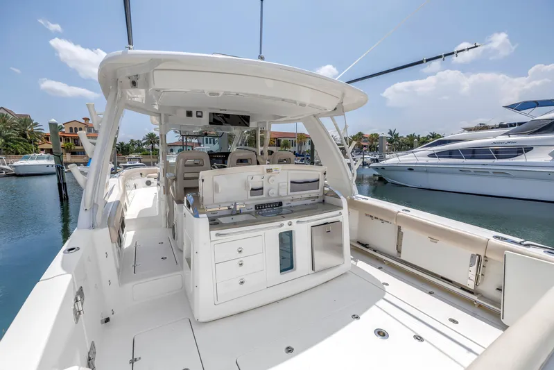  Yacht Photos Pics 2018 Boston Whaler 420 Outrage boat interior, docked at marina under clear sky.