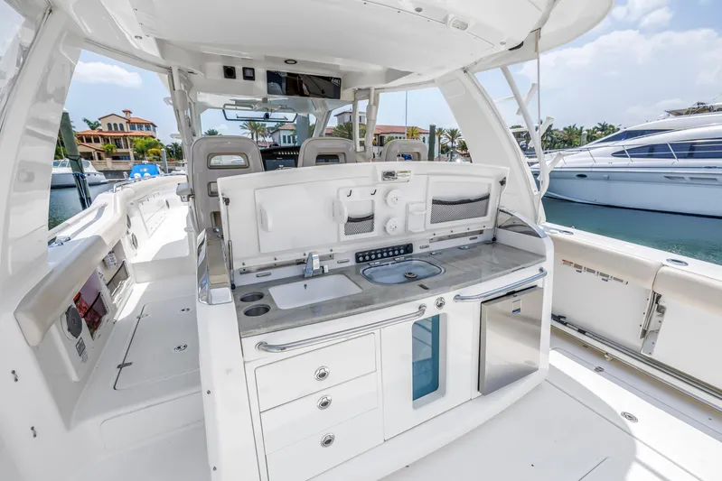  Yacht Photos Pics 2018 Boston Whaler 420 Outrage boat interior with sleek kitchen and seating area.