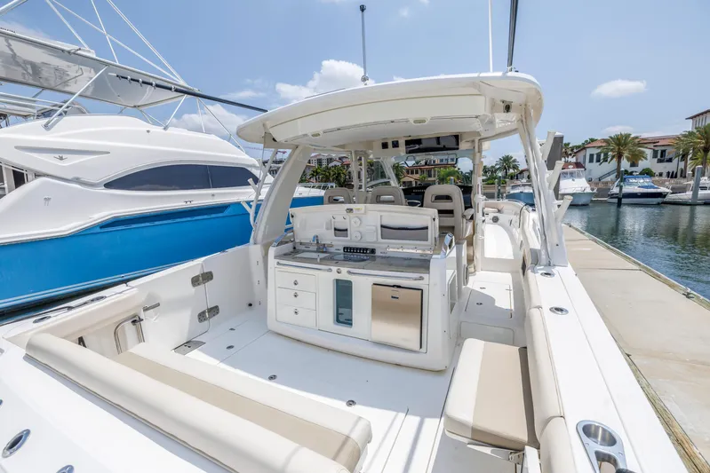  Yacht Photos Pics 2018 Boston Whaler 420 Outrage boat interior at marina, featuring seating and helm station.