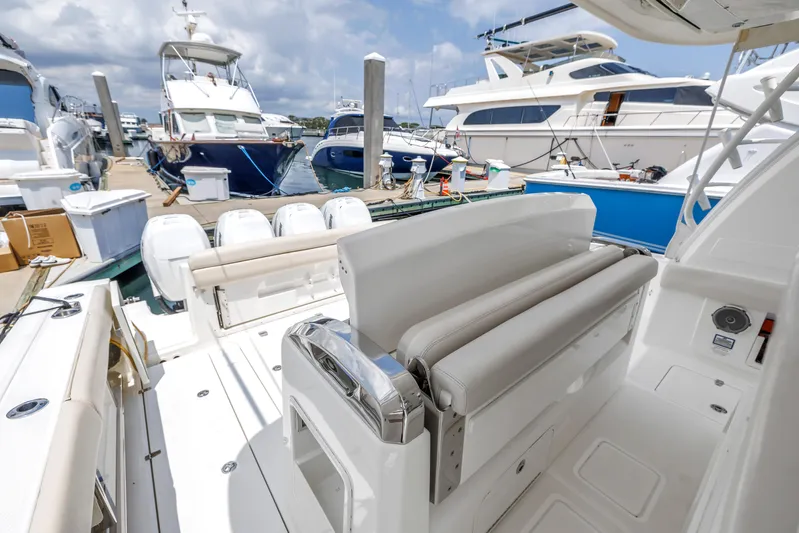  Yacht Photos Pics 2018 Boston Whaler 420 Outrage docked, showcasing spacious seating and sleek design.