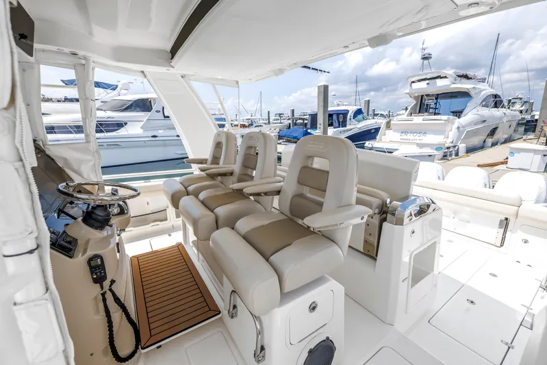  Yacht Photos Pics 2018 Boston Whaler 420 Outrage interior with helm seats and marina view.