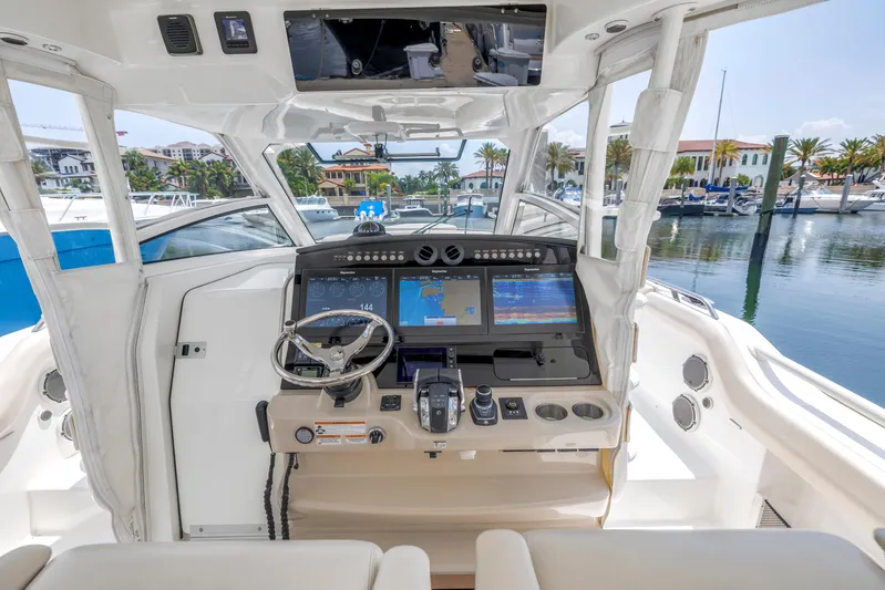  Yacht Photos Pics 2018 Boston Whaler 420 Outrage helm with advanced navigation systems, docked in a marina.