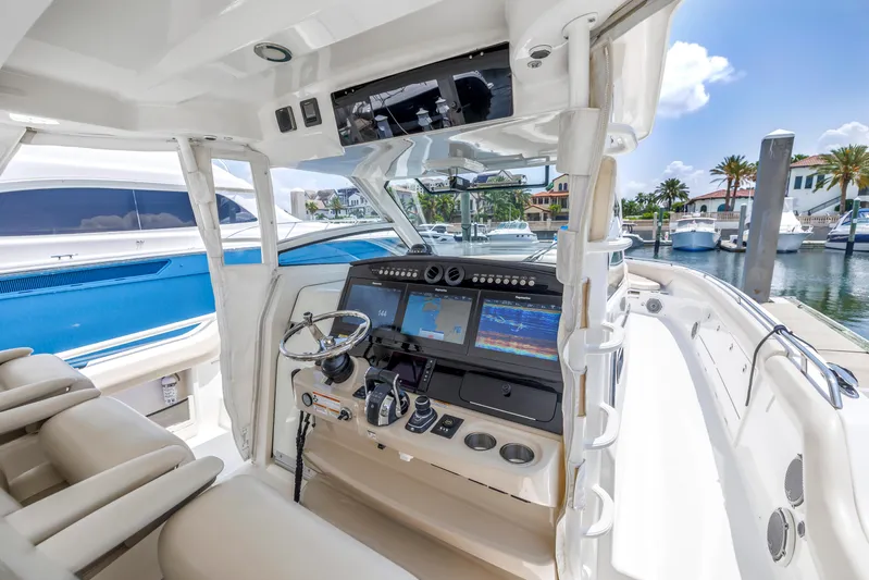  Yacht Photos Pics 2018 Boston Whaler 420 Outrage helm with advanced navigation systems, docked at marina.