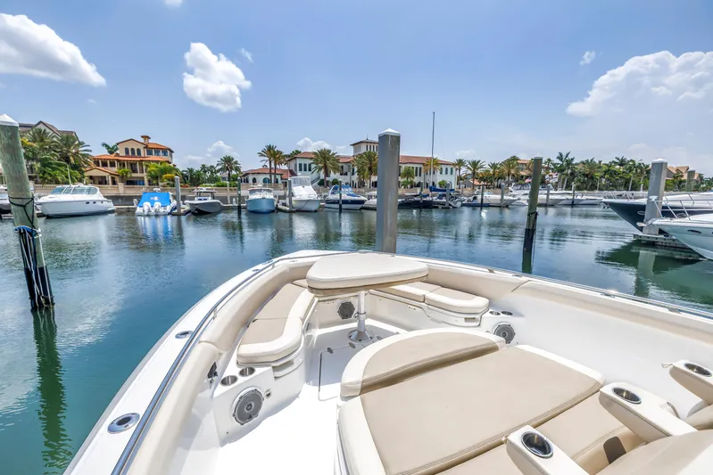  Yacht Photos Pics 2018 Boston Whaler 420 Outrage in a sunny marina with luxury boats and waterfront homes.
