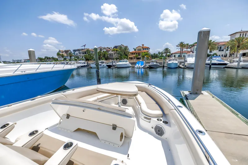  Yacht Photos Pics 2018 Boston Whaler 420 Outrage docked at a scenic marina with boats and waterfront homes.