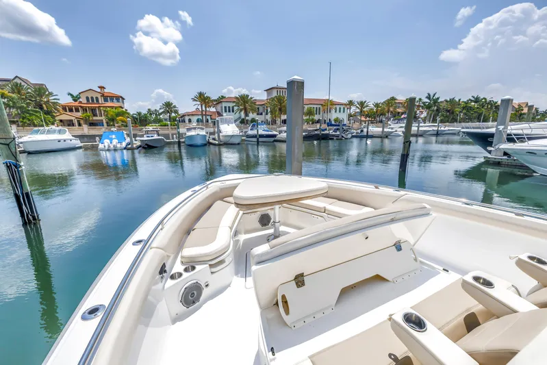  Yacht Photos Pics 2018 Boston Whaler 420 Outrage in marina, surrounded by luxury boats and waterfront homes.