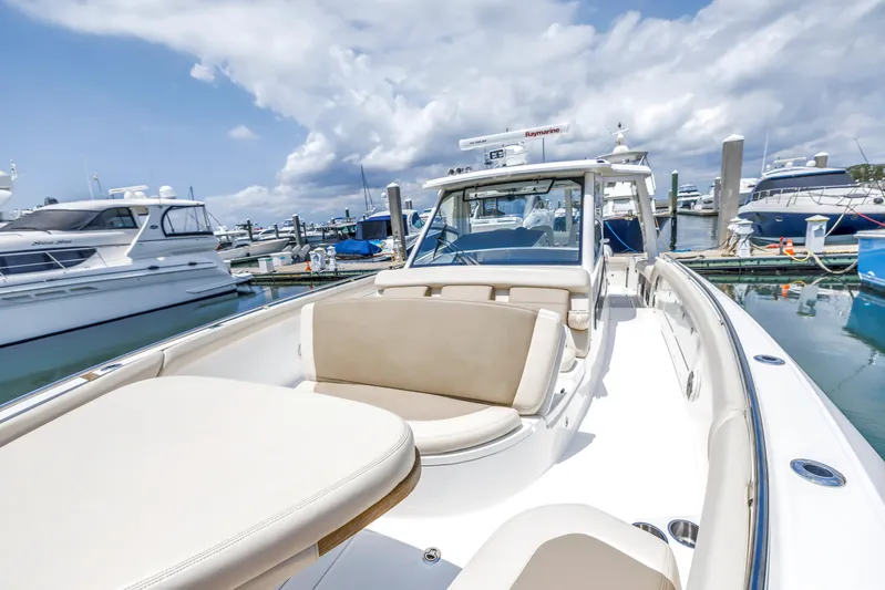  Yacht Photos Pics 2018 Boston Whaler 420 Outrage docked, showcasing sleek design and spacious seating.