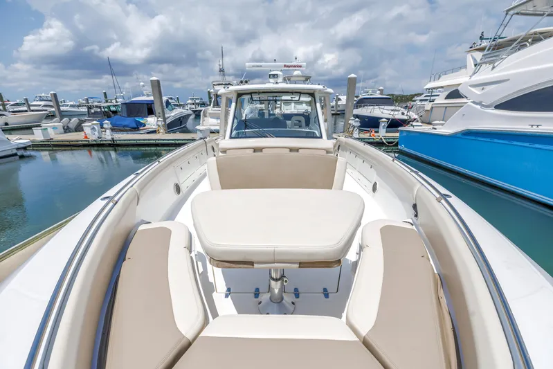  Yacht Photos Pics 2018 Boston Whaler 420 Outrage boat docked at marina, featuring spacious seating and table.