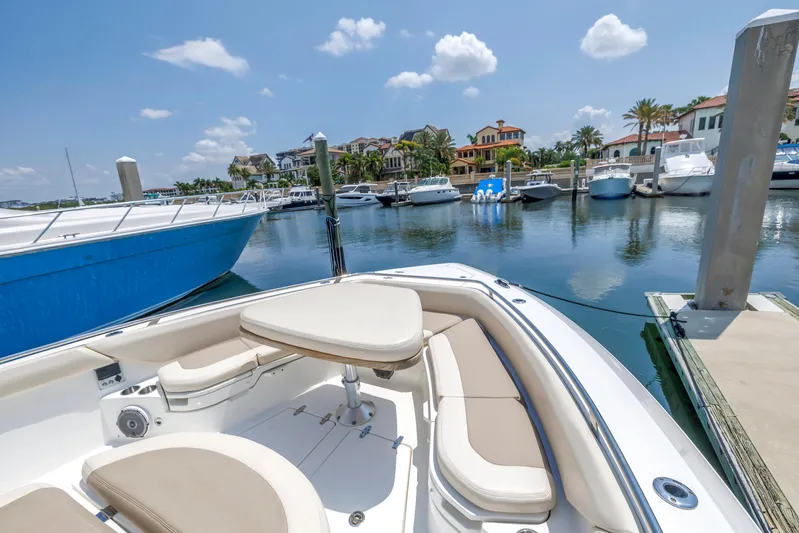  Yacht Photos Pics 2018 Boston Whaler 420 Outrage docked in a scenic marina with luxury homes.