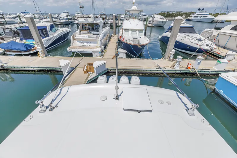  Yacht Photos Pics 2018 Boston Whaler 420 Outrage docked at a marina with other boats.