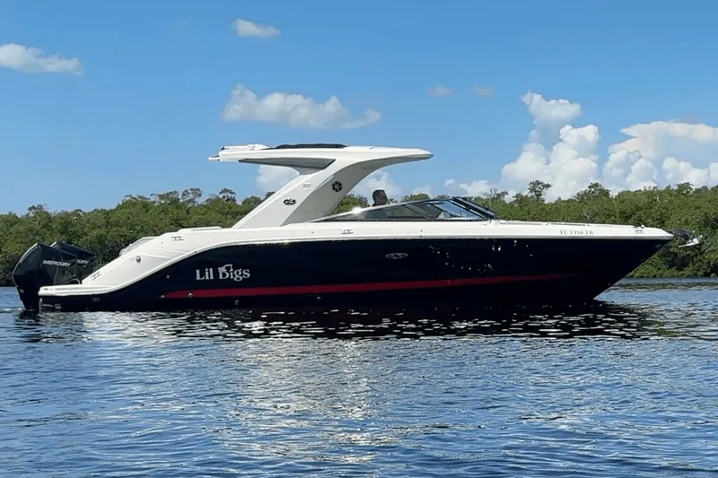  Yacht Photos Pics 2022 Sea Ray 310SLX OB boat on calm water with clear sky background.