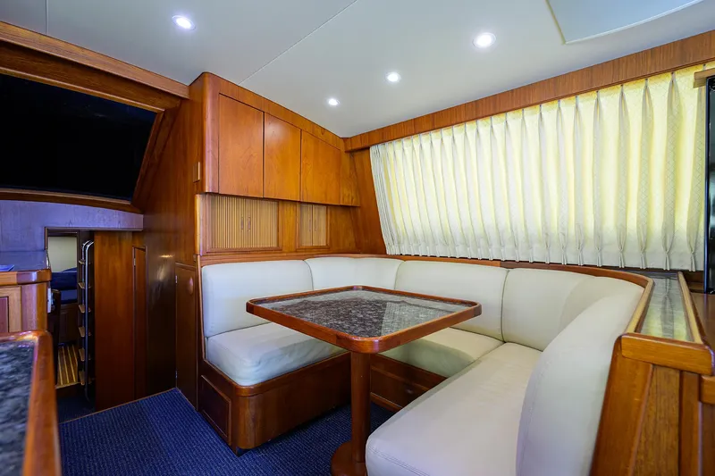 Hurricane Yacht Photos Pics Interior of 1997 Garlington 61 Convertible yacht with cozy seating and wooden accents.