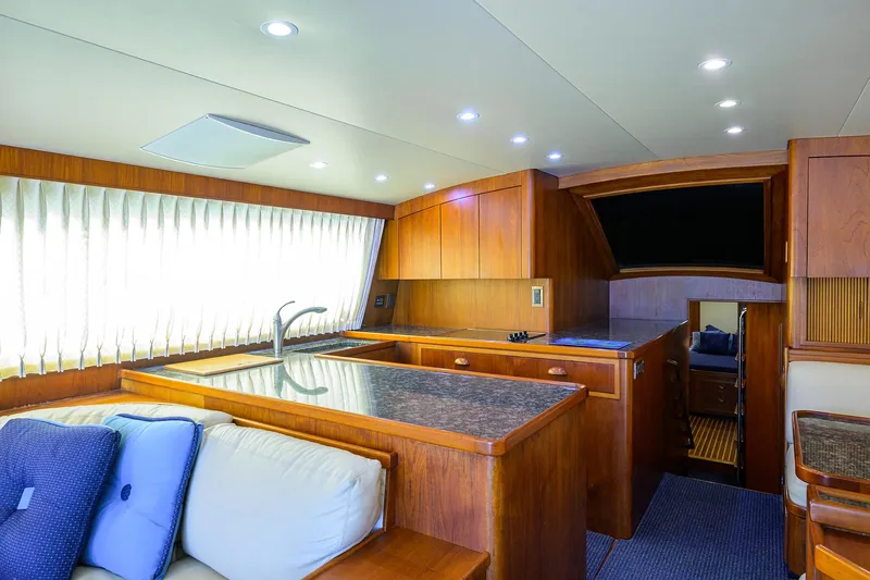 Hurricane Yacht Photos Pics Luxurious interior of 1997 Garlington 61 Convertible yacht with modern kitchen and seating area.