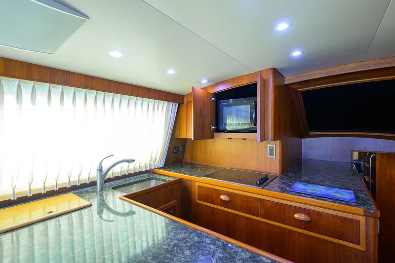 Hurricane Yacht Photos Pics Luxurious kitchen interior of 1997 Garlington 61 Convertible yacht with modern amenities.