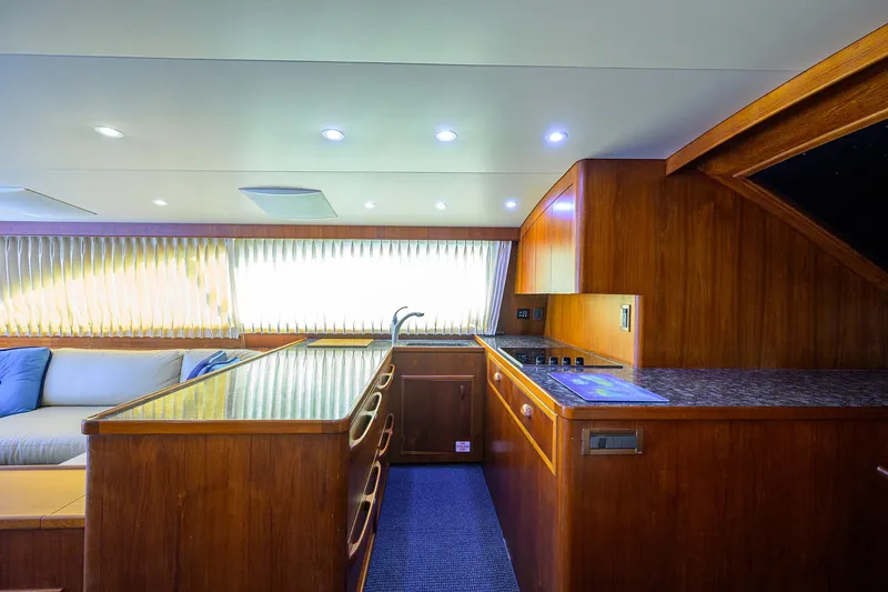 Hurricane Yacht Photos Pics Interior of a 1997 Garlington 61 Convertible yacht with wooden cabinetry and modern lighting.