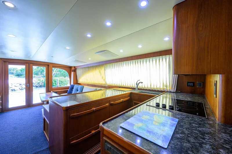 Hurricane Yacht Photos Pics Luxurious interior of a 1997 Garlington 61 Convertible yacht with modern kitchen and seating area.