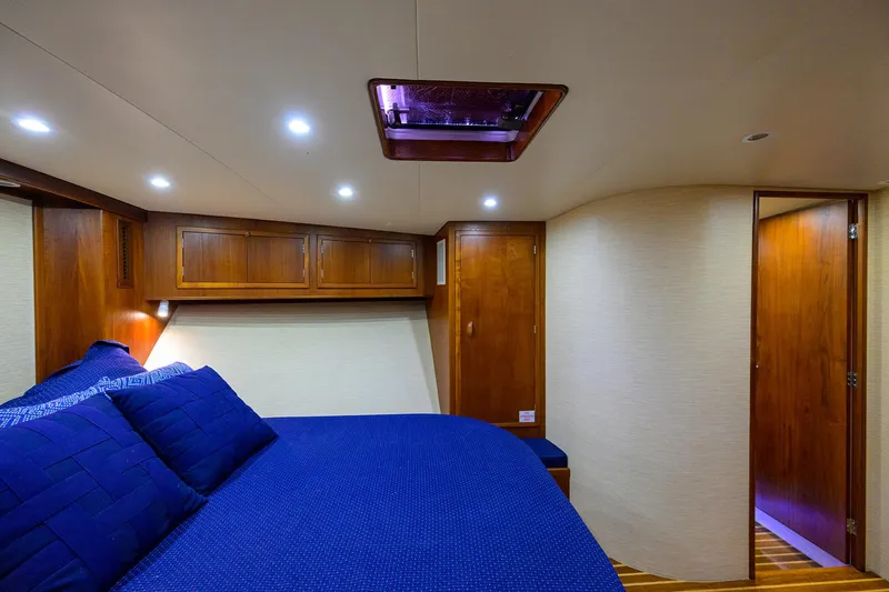 Hurricane Yacht Photos Pics Luxurious cabin interior of a 1997 Garlington 61 Convertible yacht with blue bedding.