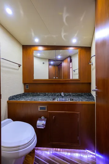 Hurricane Yacht Photos Pics Luxurious bathroom in a 1997 Garlington 61 Convertible yacht with wood accents and modern fixtures.