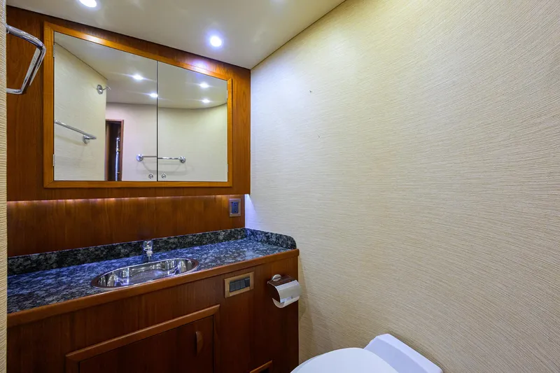 Hurricane Yacht Photos Pics Luxurious bathroom interior of 1997 Garlington 61 Convertible yacht with wood accents and granite countertop.