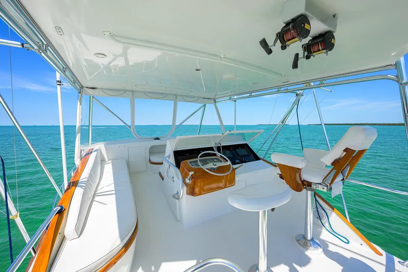 Hurricane Yacht Photos Pics 1997 Garlington 61 Convertible yacht helm with ocean view, featuring white seating and steering wheel.