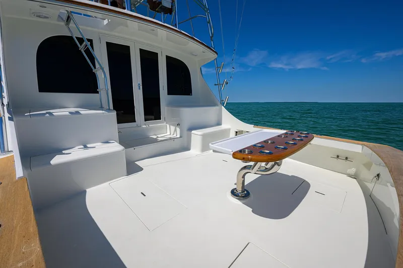 Hurricane Yacht Photos Pics 1997 Garlington 61 Convertible yacht deck with fishing chair, ocean view, and clear blue sky.