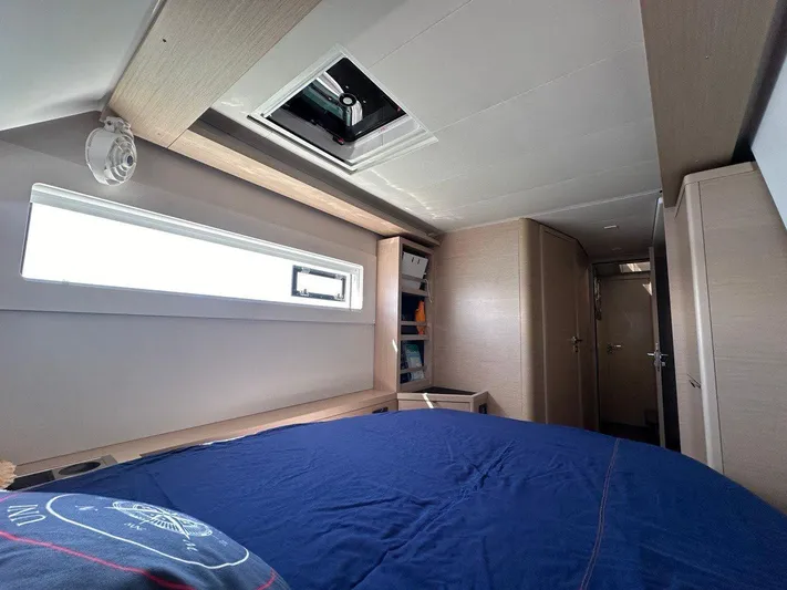 Uni Yacht Photos Pics Interior cabin of 2023 Lagoon 46 yacht with modern design and blue bedding.