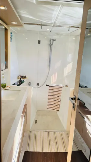Uni Yacht Photos Pics Modern bathroom in 2023 Lagoon 46 yacht with shower and sleek design.
