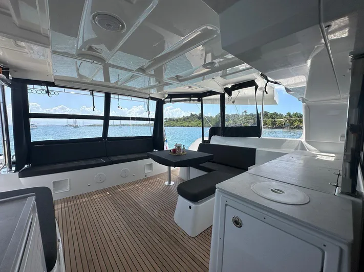 Uni Yacht Photos Pics Modern 2023 Lagoon 46 catamaran interior with sleek seating and ocean view.
