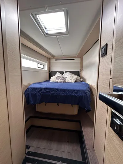 Uni Yacht Photos Pics 2023 Lagoon 46 yacht cabin with cozy bed and modern interior design.