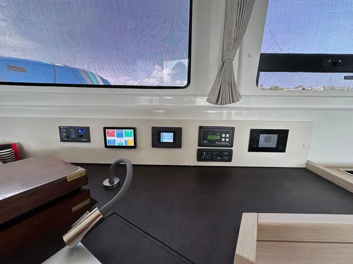 Uni Yacht Photos Pics Control panel inside 2023 Lagoon 46 yacht, featuring modern navigation and monitoring systems.