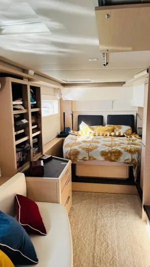 Uni Yacht Photos Pics Interior of 2023 Lagoon 46 yacht with cozy bedroom and modern furnishings.
