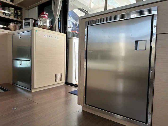 Uni Yacht Photos Pics Modern kitchen interior of 2023 Lagoon 46 yacht with stainless steel appliances.