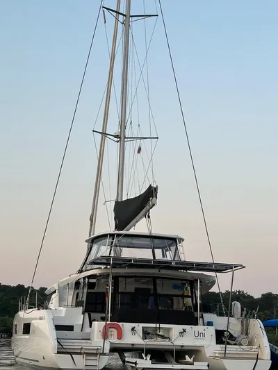 Uni Yacht Photos Pics 2023 Lagoon 46 catamaran docked, showcasing sleek design and modern features.