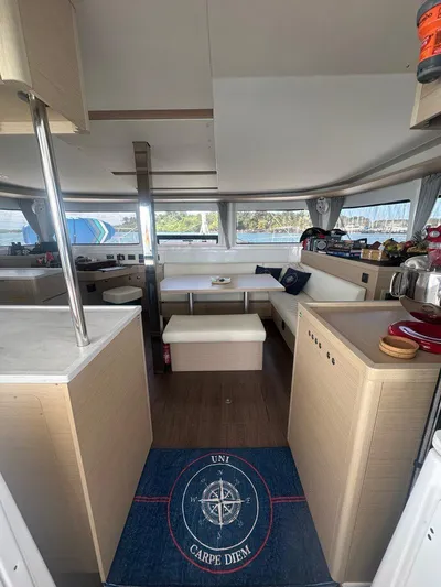 Uni Yacht Photos Pics Interior of 2023 Lagoon 46 catamaran with modern seating and nautical decor.