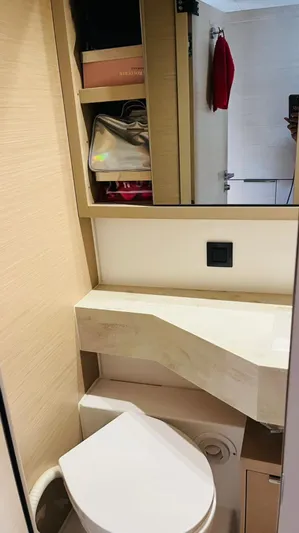 Uni Yacht Photos Pics 2023 Lagoon 46 yacht bathroom with modern fixtures and storage shelves.