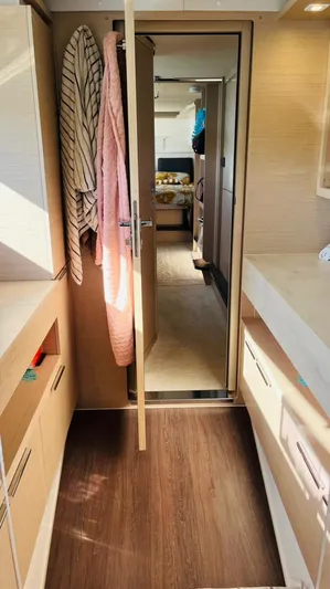 Uni Yacht Photos Pics Interior of 2023 Lagoon 46 yacht with modern wood finish and cozy hallway.