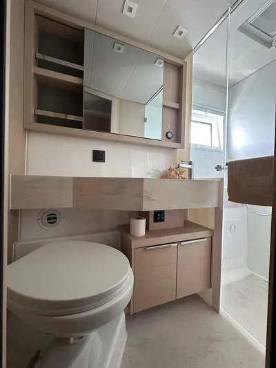 Uni Yacht Photos Pics Modern bathroom in 2023 Lagoon 46 yacht with sleek fixtures and ample storage.