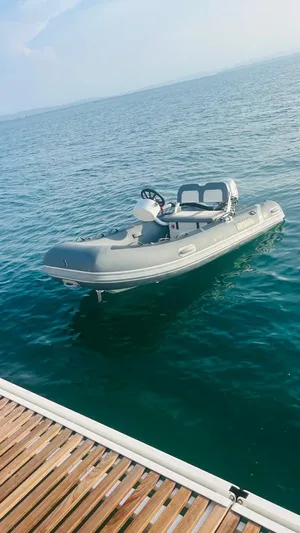 Uni Yacht Photos Pics Inflatable boat docked on calm water, clear sky, Lagoon 46, 2023 model.